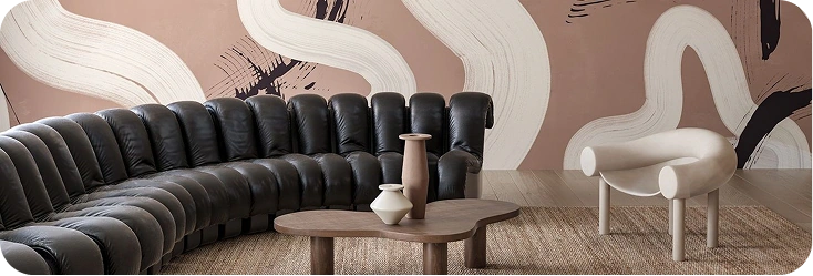 Abstract brushstroke mural behind a curved black sofa