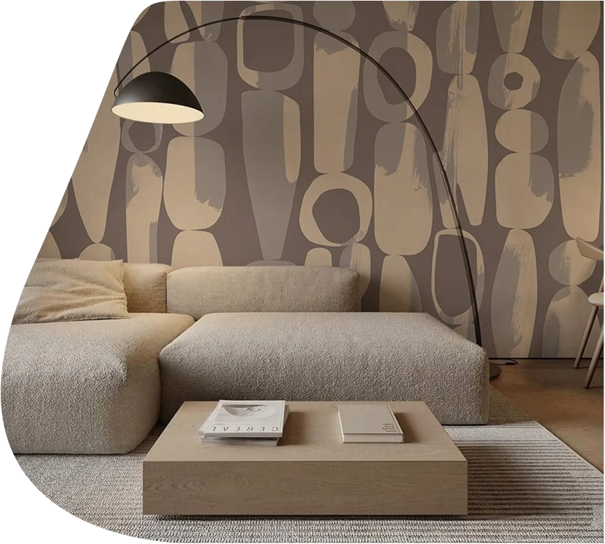 Abstract pebble wallpaper behind a modern sofa and lamp.
