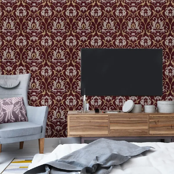 Elegant burgundy damask wallpaper behind a wooden TV console