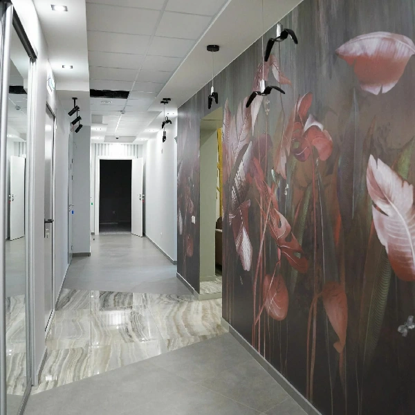 Large botanical mural on a hallway wall with polished marble floor tiles.