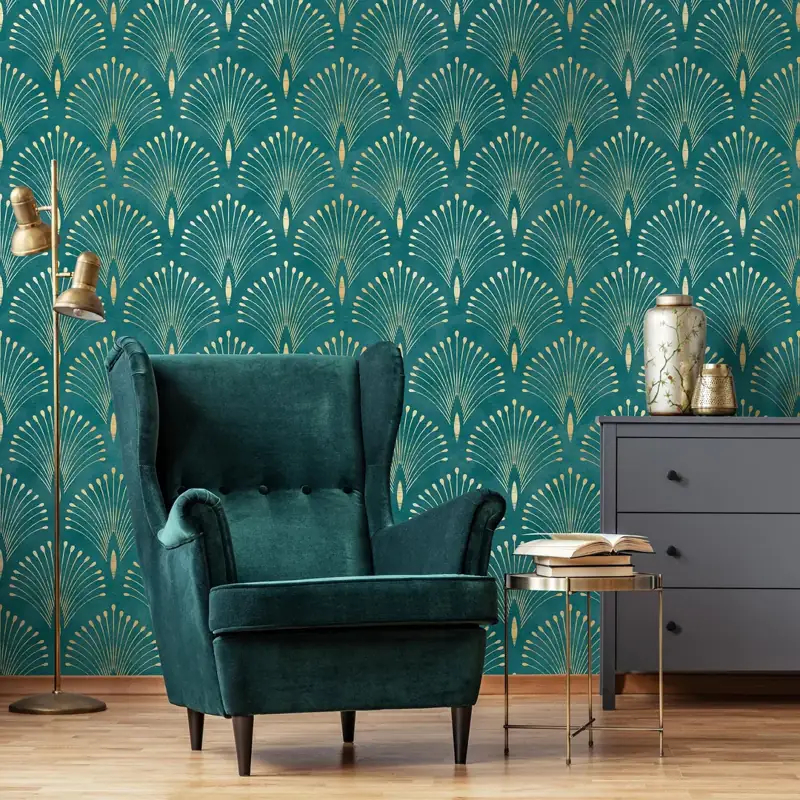 Teal wallpaper with gold fan patterns behind a chair