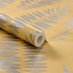 wallpaper with silver metallic leaf patterns on a mustard yellow background.